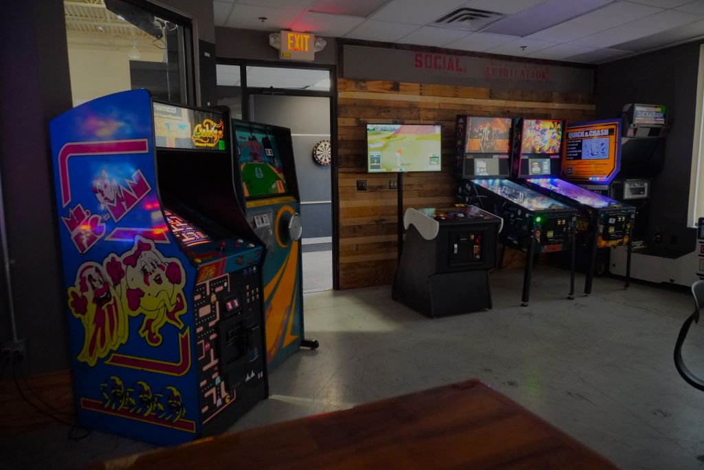 This image shows the pacman machine, some pinball machines, and the enterance to the dart room.